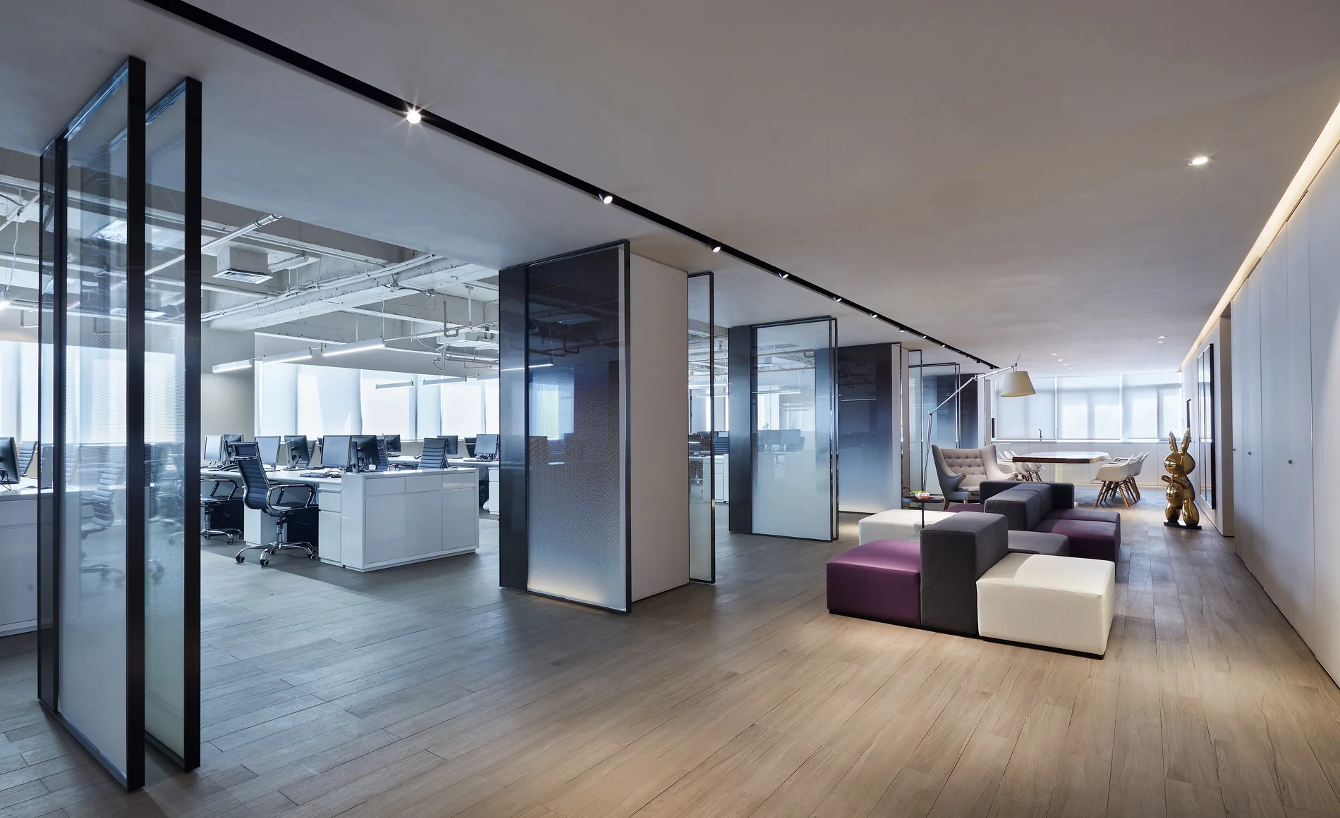 Minimal creative workplace with flexible glass partitions